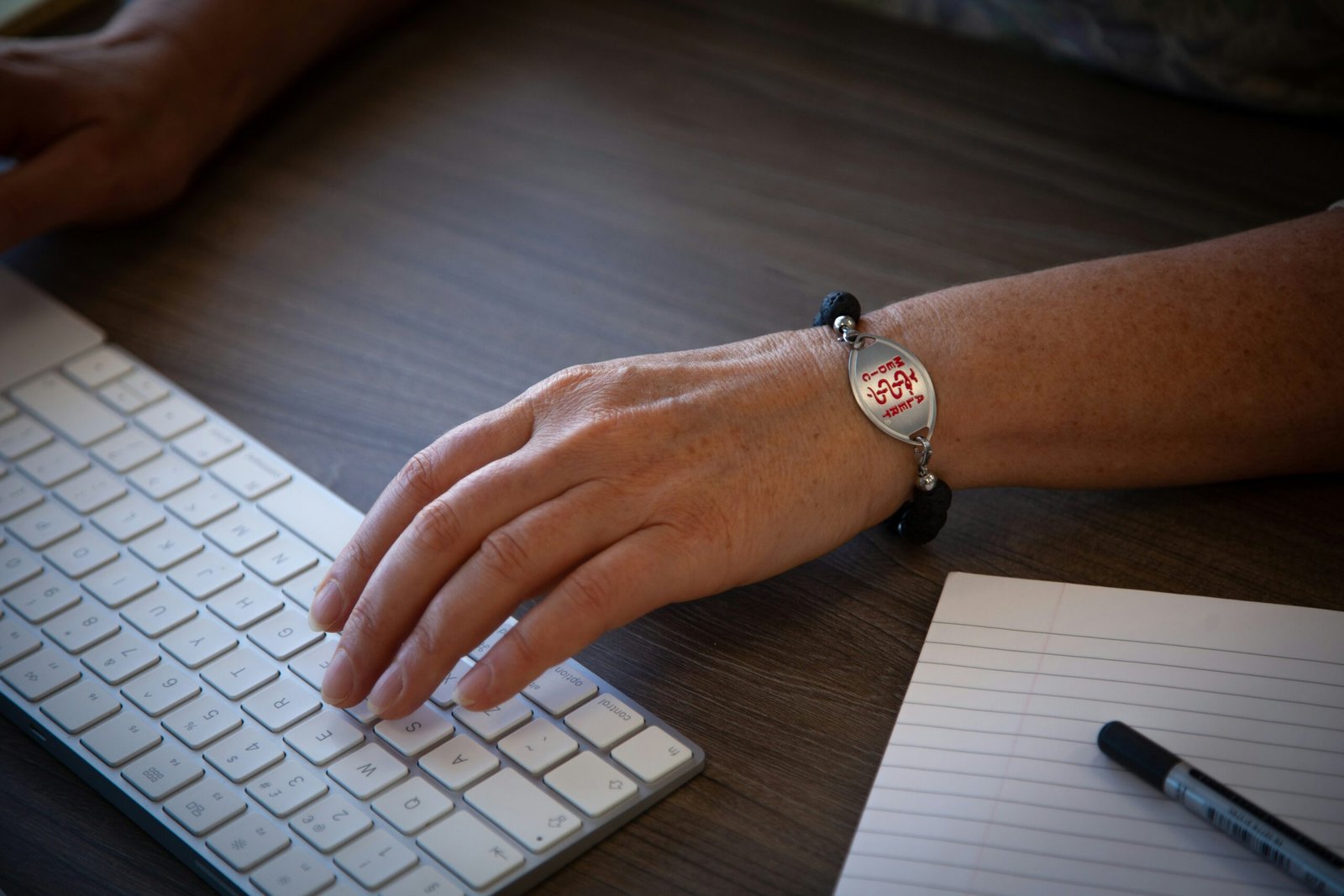 person wearing silver round analog watch